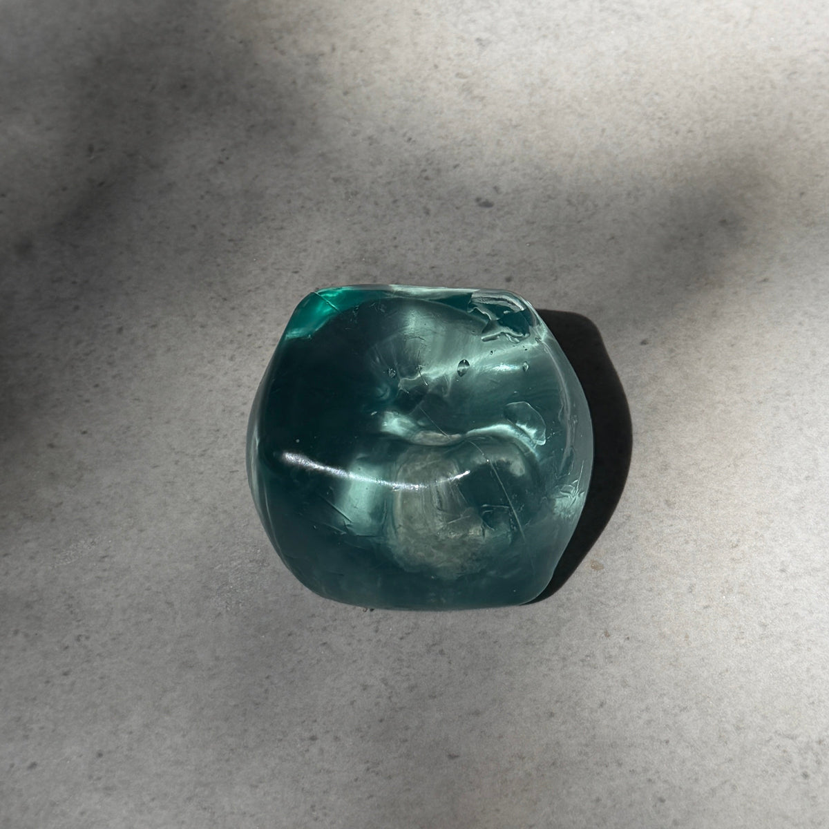 Mint maltose cube squishy stress toy with translucent glossy finish, soft moldable texture, and satisfying slow rebound after squeezing.