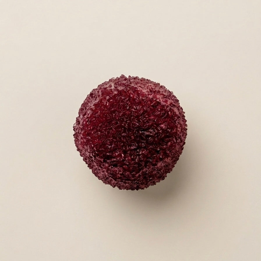 Dark Red berry slushy squishy stress ball. Color is burgundy cherry.  Squishy ball best for asmr fidgets toy. A single dark red, textured spherical squishy ball with a rough, crystalline or granular surface, centered on a plain off-white background.