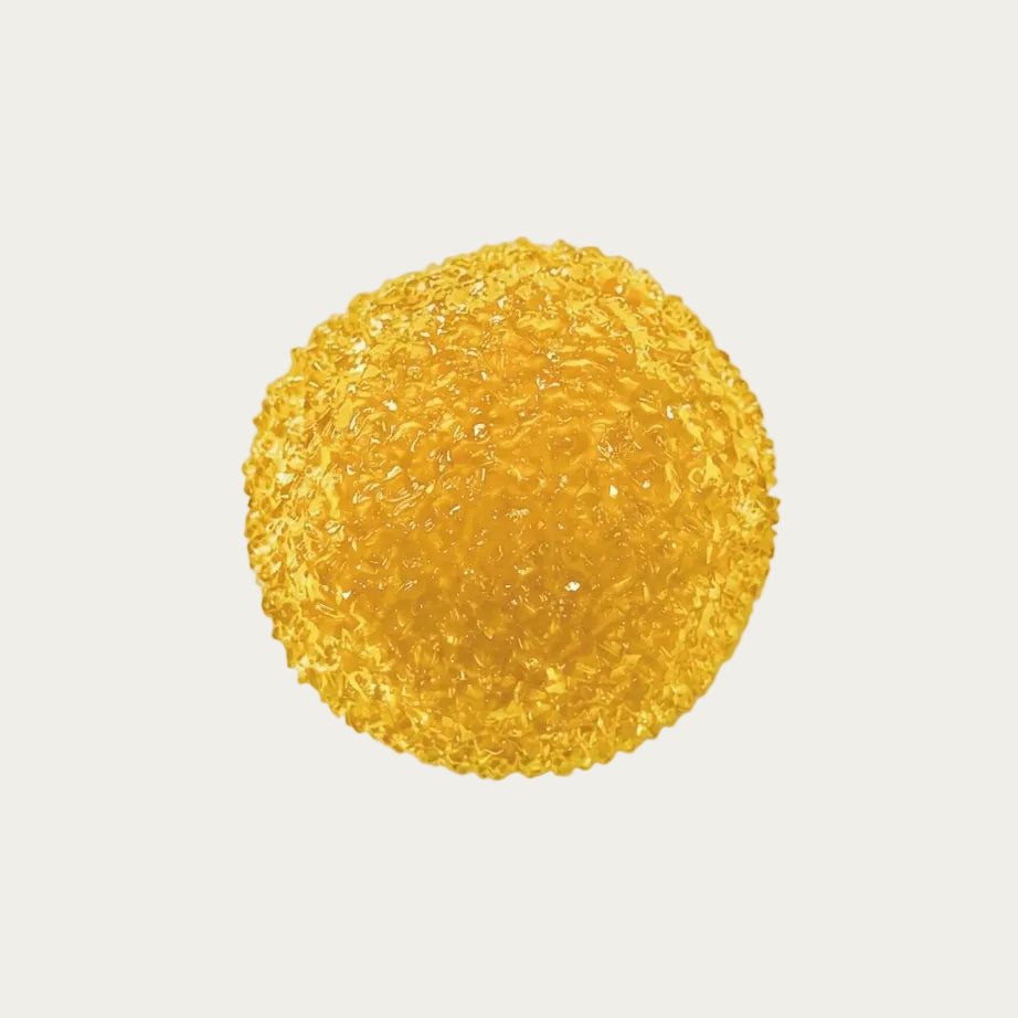 Golden berry slushy squishy stress ball. Color is Golden Honey.  Squishy ball best for asmr fidgets toy. A round, textured golden-yellow object with a bubbly, crystalline surface, photographed from above on a plain light background.