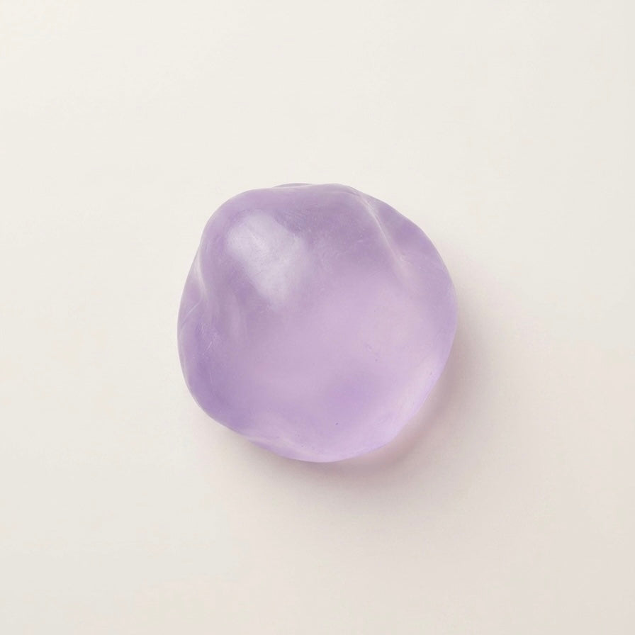 Purple coconut oil sugar ball squishy stress ball with a translucent glossy finish and soft moldable texture.