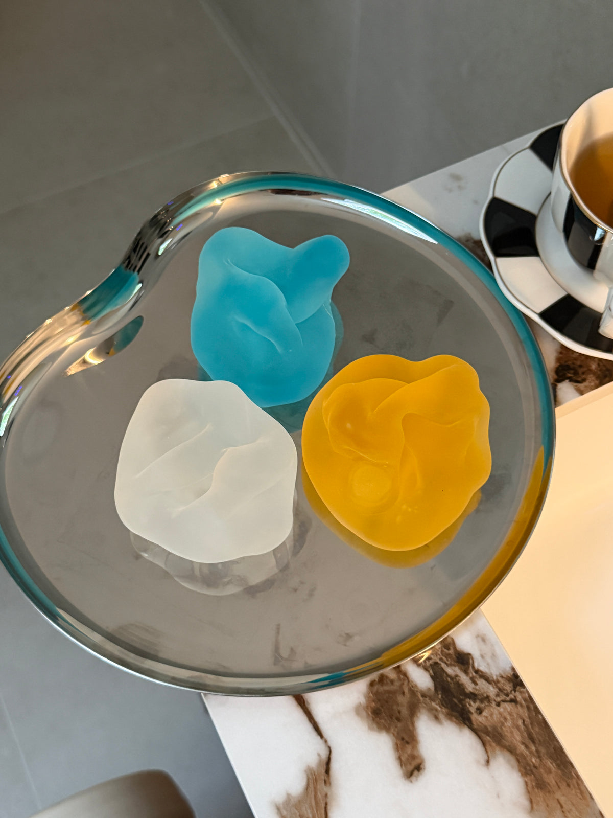 Blue, clear and yellow SQUU slime-vaseline-based mochi squishies for sensory play, stress relief and satisfying ASMR.