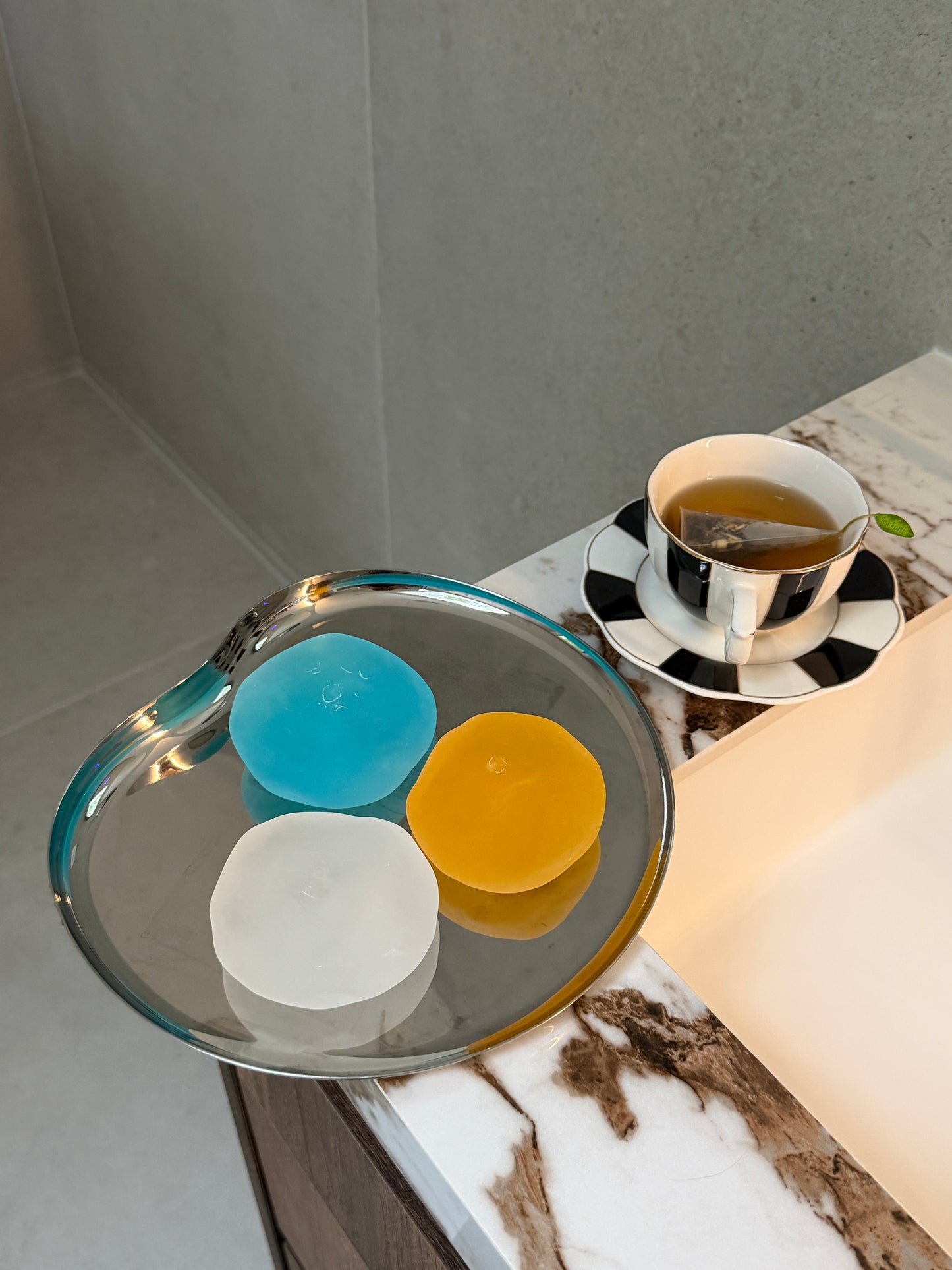 Blue, clear and orange SQUU slime-based mochi squishies with a soft moldable texture for sensory play, stress relief and ASMR.