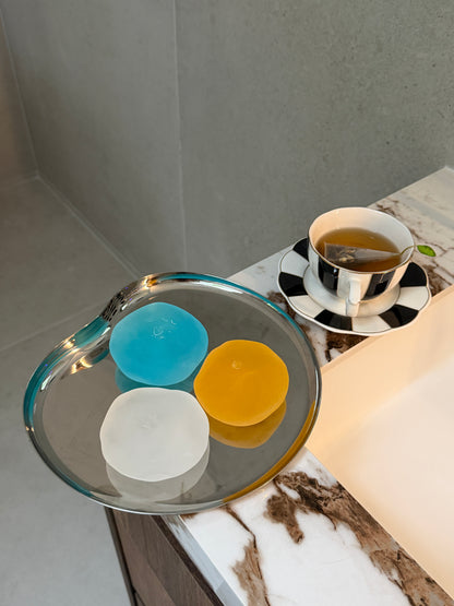 Blue, clear and orange SQUU slime-based mochi squishies with a soft moldable texture for sensory play, stress relief and ASMR.