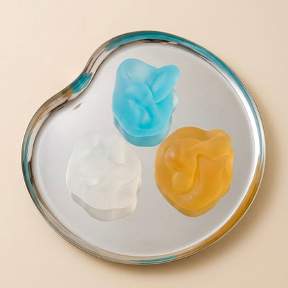 Blue, clear and amber translucent SQUU squishy stress toys for sensory play and satisfying ASMR Matte mochi texture and maximum satisfaction. 