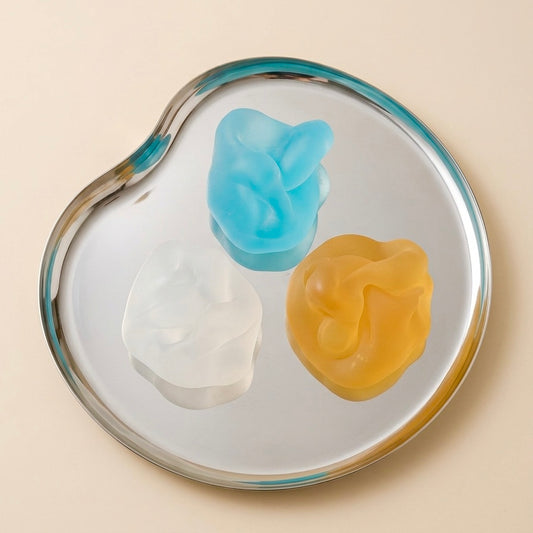 Blue, clear and amber translucent SQUU squishy stress toys for sensory play and satisfying ASMR Matte mochi texture and maximum satisfaction. 