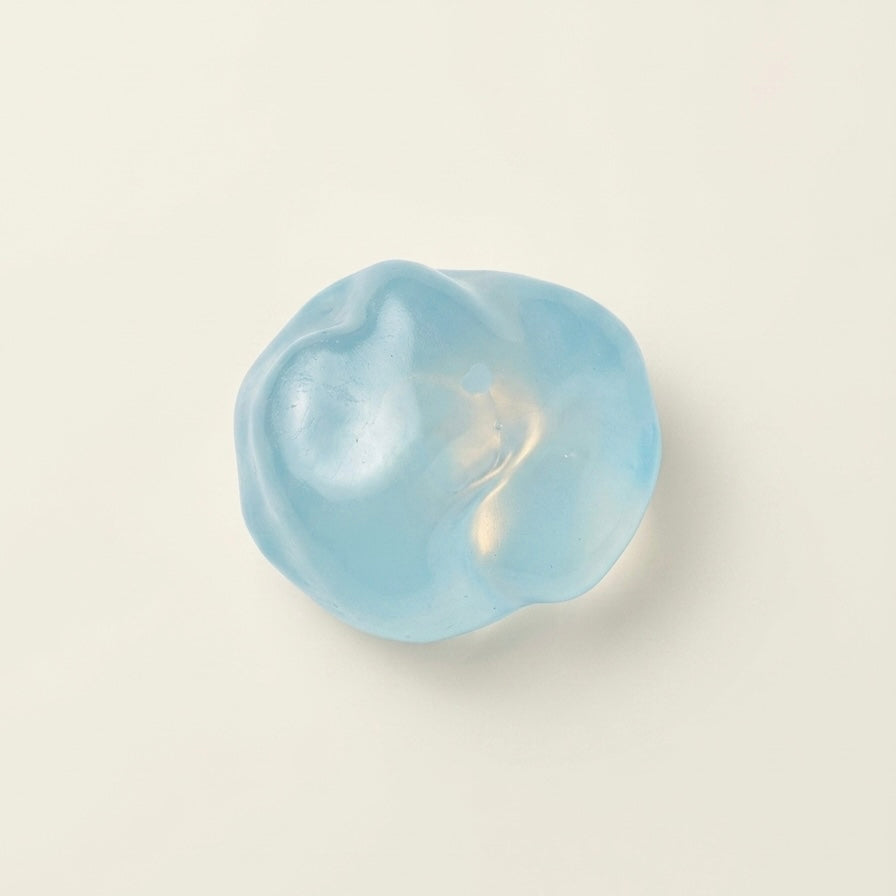 Blue coconut oil sugar ball squishy stress ball with a translucent glossy finish and soft moldable texture.