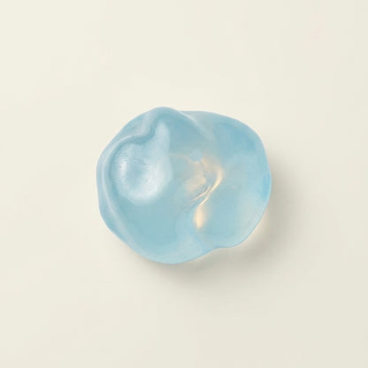 Blue coconut oil sugar ball squishy stress ball with a translucent glossy finish and soft moldable texture.