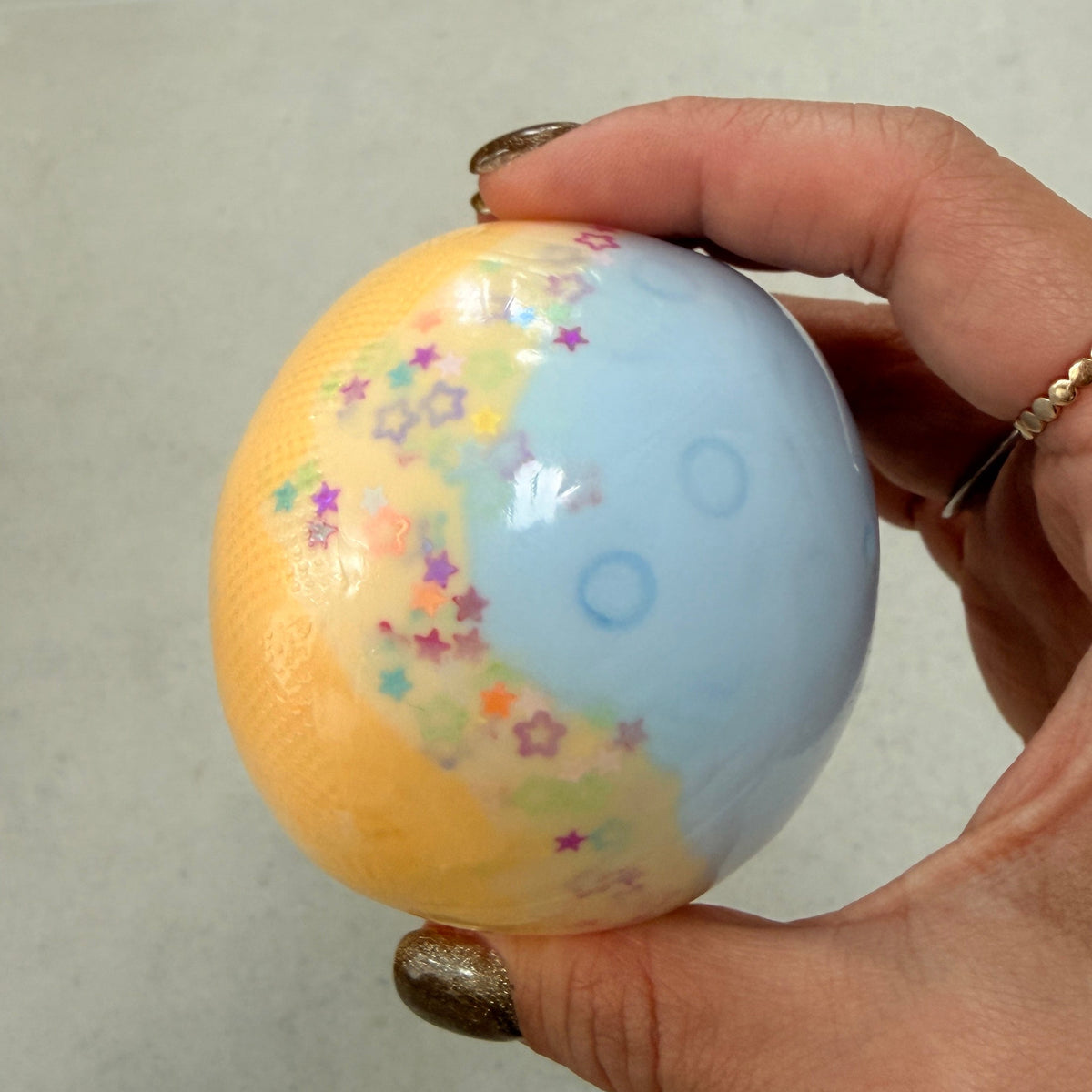 Blue Spirulina Cheese Duo squishy stress ball with moldable cream filling, crunchy rice sensory texture, slow rebound, and colorful star confetti.