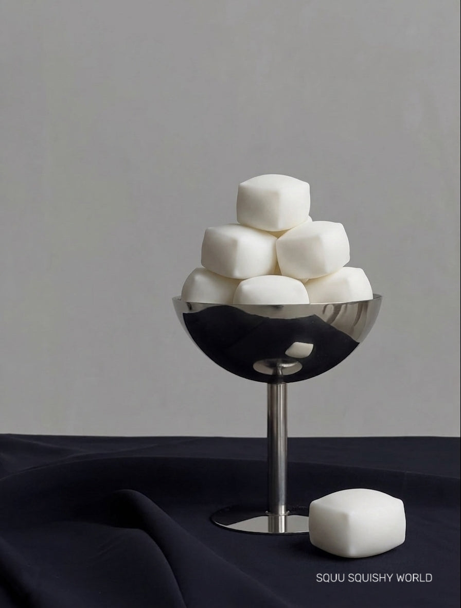 Ultra-fluffy Cloud Tofu squishy stress cubes with soft airy texture and matte white finish displayed as a SQUU collection.