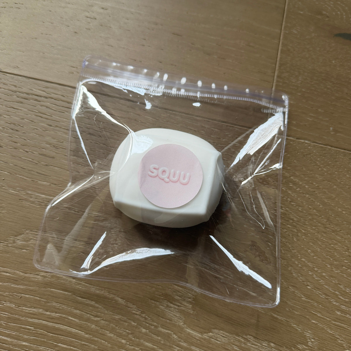 Ultra-fluffy Cloud Tofu squishy stress cube packaged in a clear SQUU bag with a matte white surface and branded pink label.