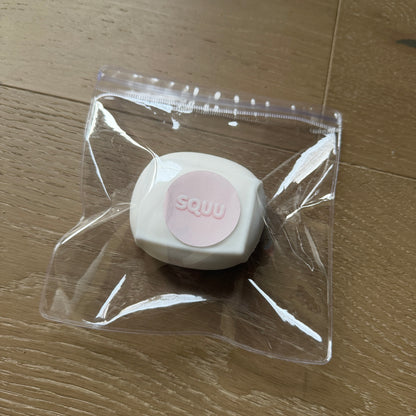 Ultra-fluffy Cloud Tofu squishy stress cube packaged in a clear SQUU bag with a matte white surface and branded pink label.