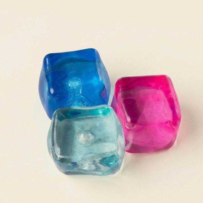 Three translucent cube squishy in blue, mint and pink color with square-shaped sensory and stress-relief toy designed to be squeezed, stretched, and kneaded before slowly returning to its original form