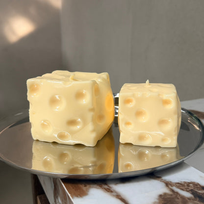 Jumbo and baby cheese squishy stress ball sensory toys displayed side by side on a silver tray.