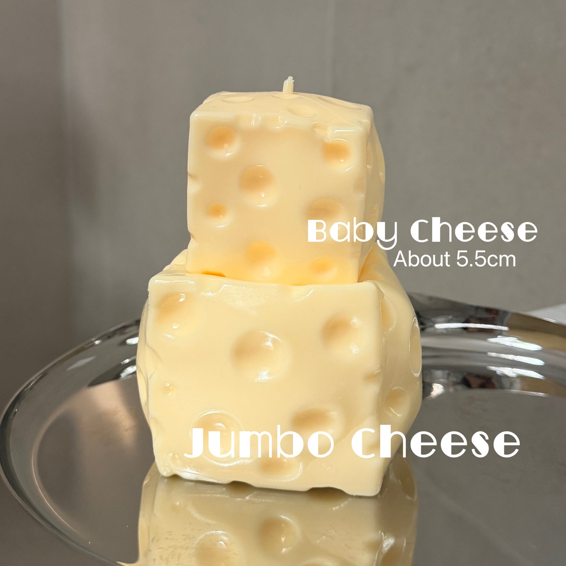 Jumbo and baby cheese squishy stress ball sensory toys stacked together for size comparison, with baby cheese measuring about 5.5 cm.