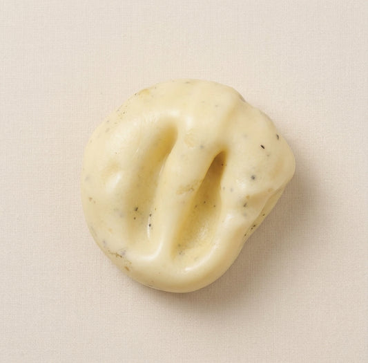 Ultra-soft Pepp mashed potato squishy stress ball with grainy texture, moldable filling, thin skin, and black pepper details.