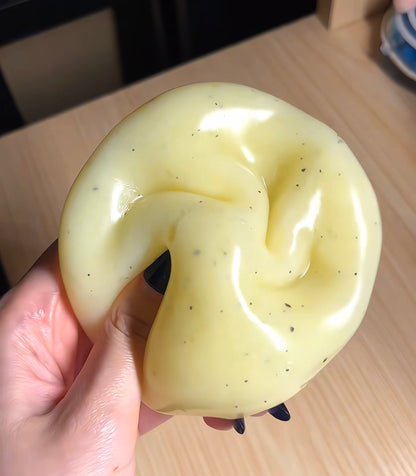 Ultra-soft moldable mashed potato squishy stress ball with grainy texture, thin skin, zero rebound, and realistic black pepper details.