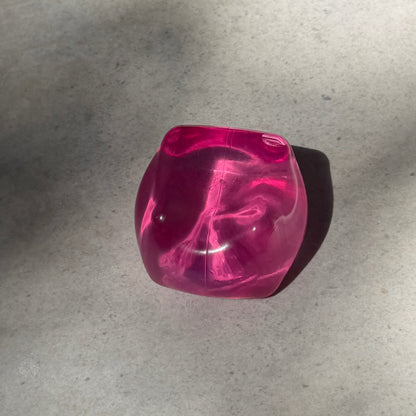 Pink maltose cube squishy stress toy with translucent glossy finish, soft moldable texture, and satisfying slow rebound after squeezing.