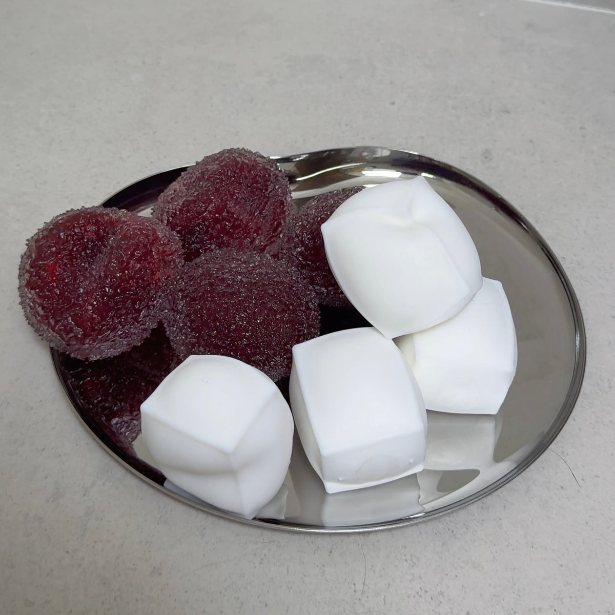 SQUU slushy berry and fluffy tofu squishy stress toys displayed together, featuring grainy slushy texture and ultra-soft airy tofu texture.