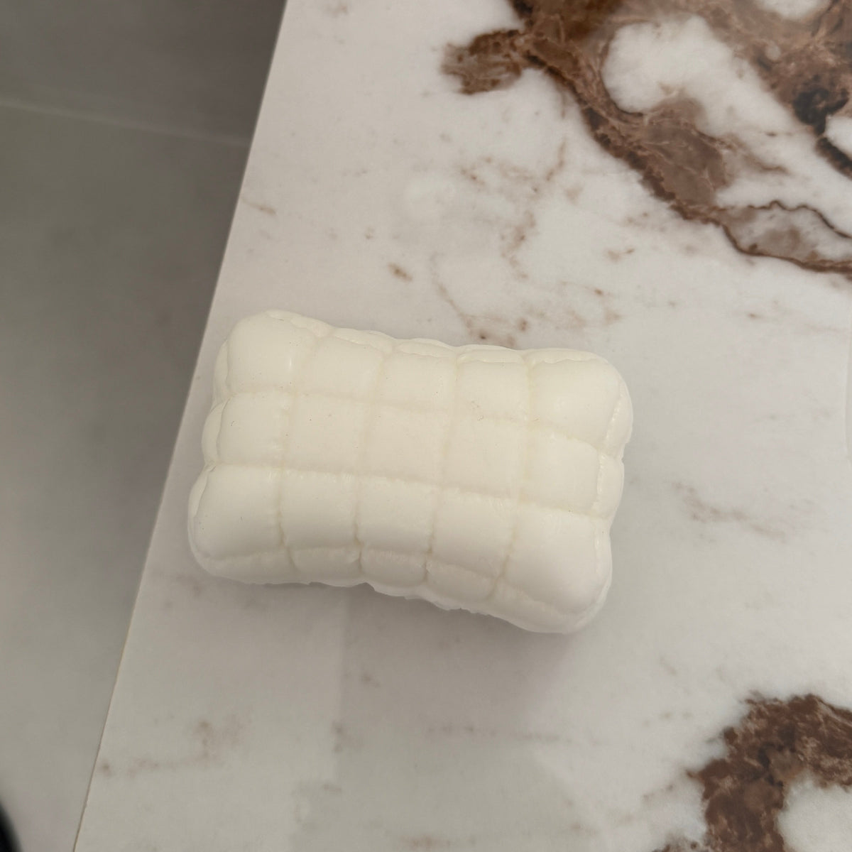 Ultra-soft sticky Mellow Pillow TABA squishy sensory toy with a white quilted cushion design for bare-hand or bag play.