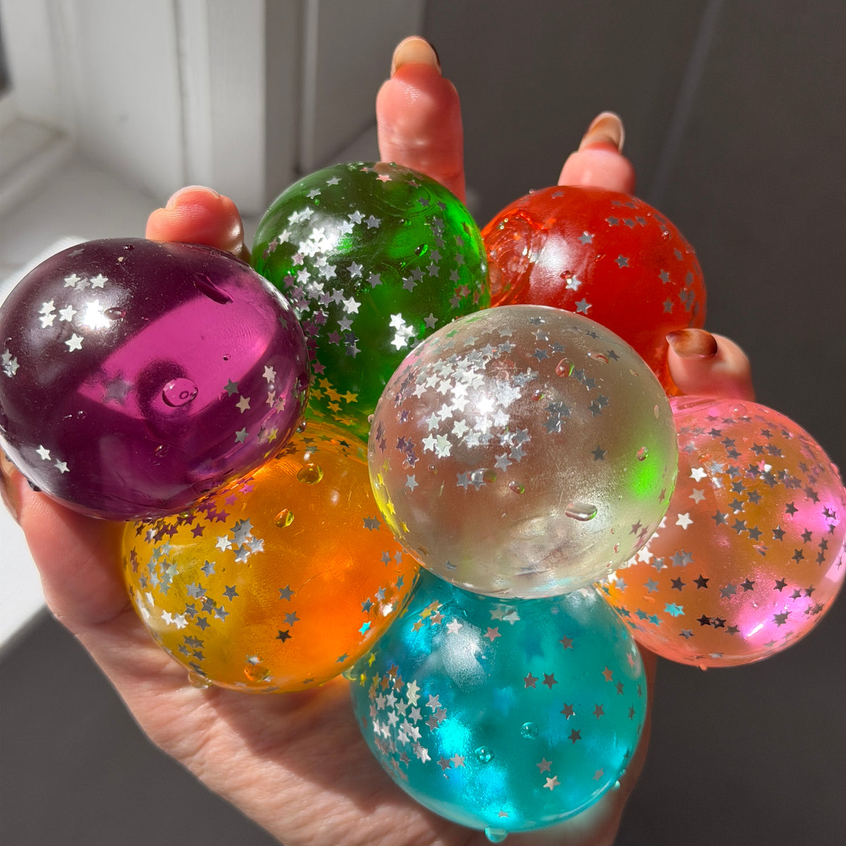 Assorted vintage-style maltose squishies in translucent colors with star-shaped glitter confetti and soft slow-rebound texture.